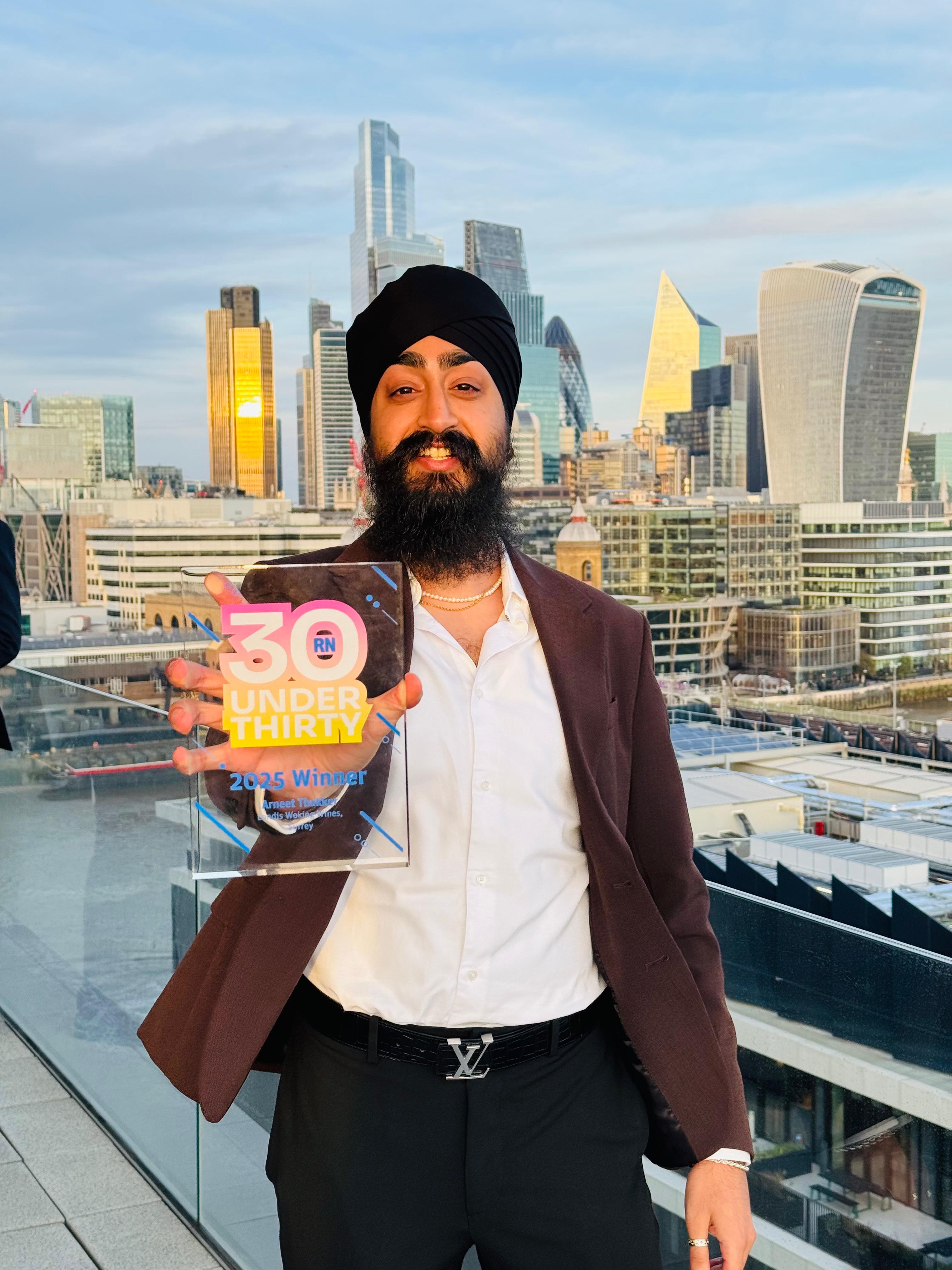 Arneet Thakker of Londis Woking Wines holding the Retail News 30 Under 30 2025 award